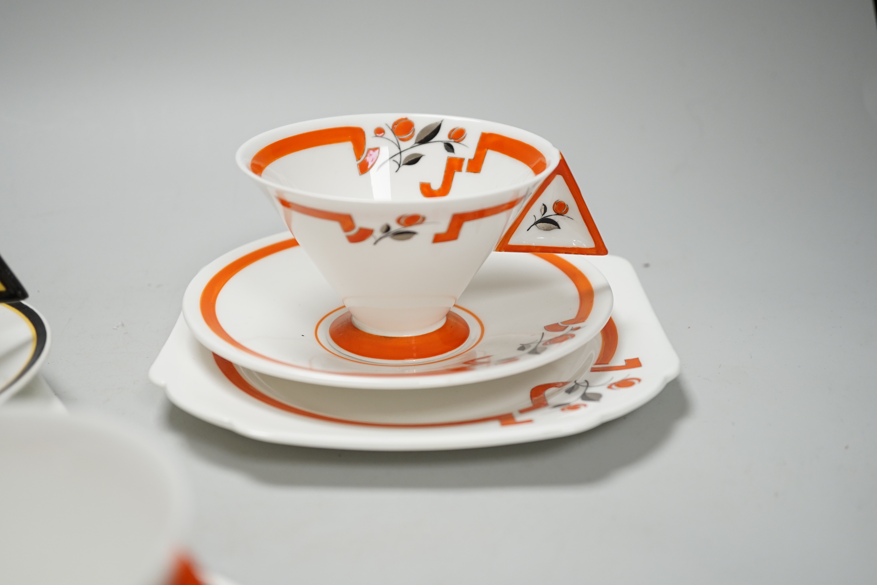 Two Art Deco Shelley Vogue shaped handled trios and a cup and saucer, largest cups 6.5cm high
